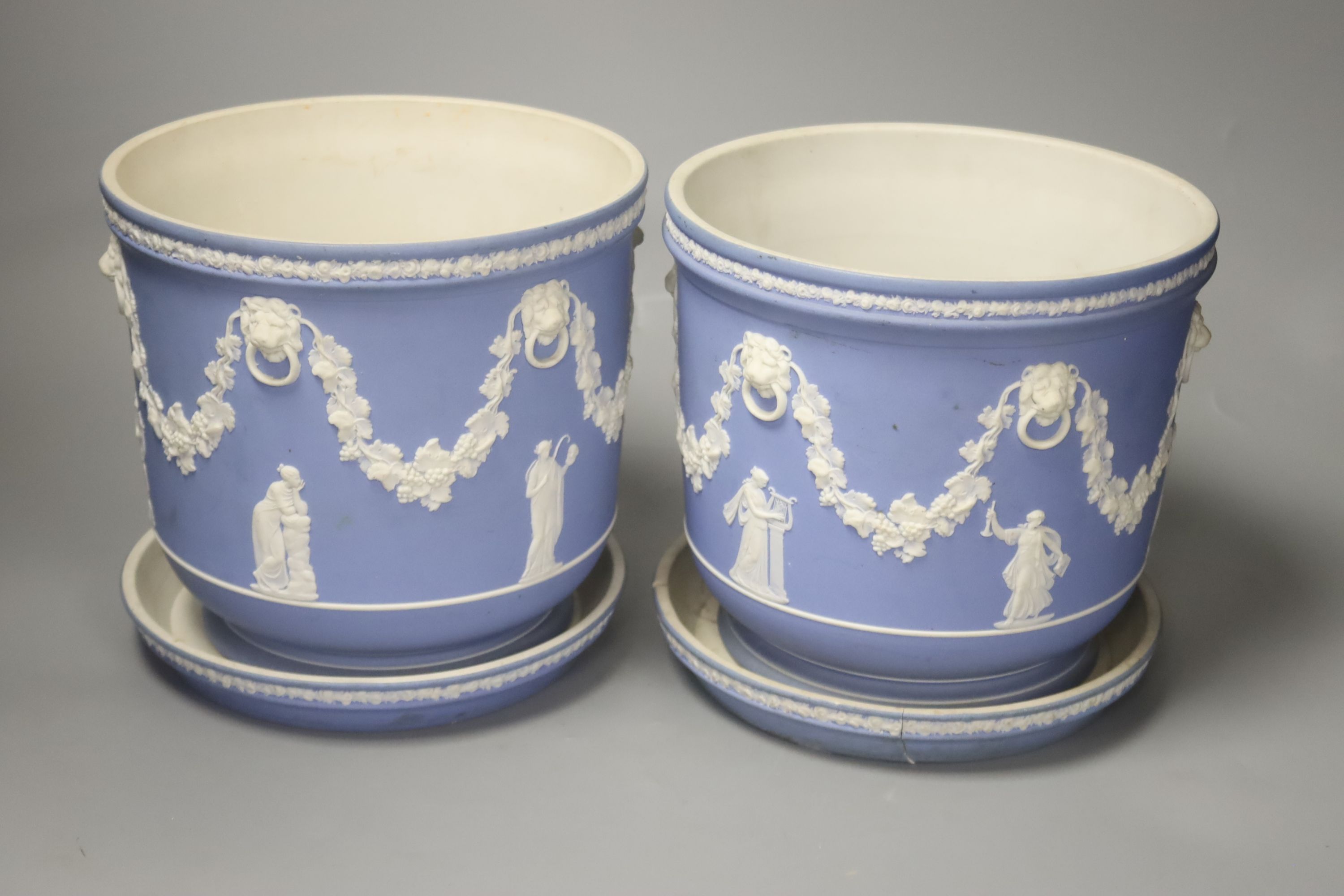 A pair of Victorian Wedgwood blue ground jasperware jardinieres and stands